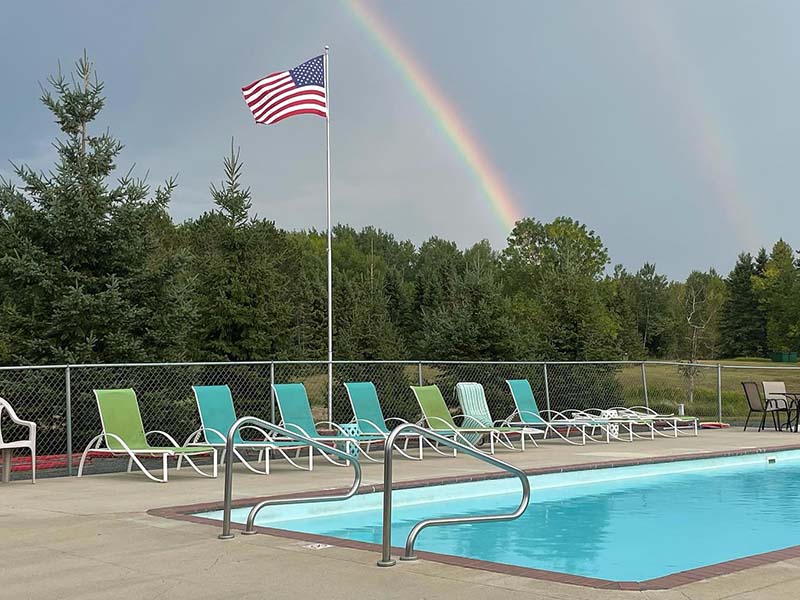 Heated Pool with rainbow at Cedar Rapids Lodge